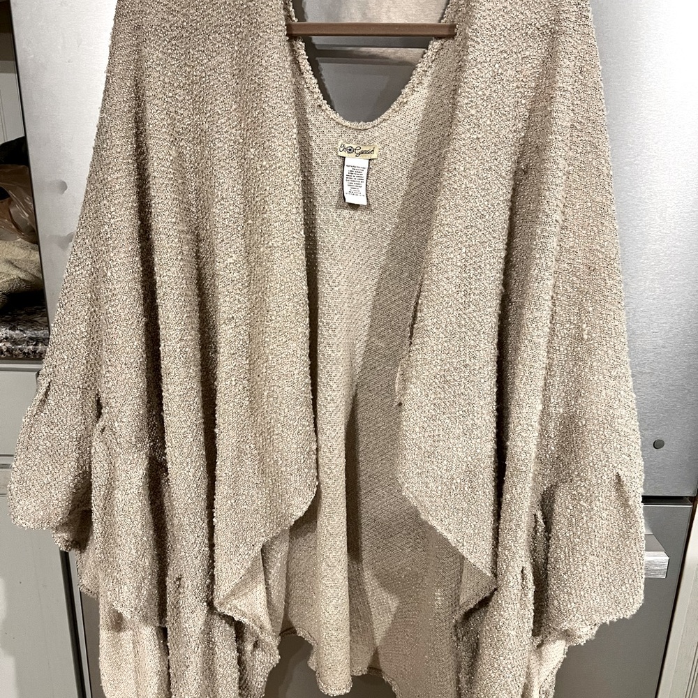 Over the shoulder shawl. No sleeves but drapes around the shoulder.